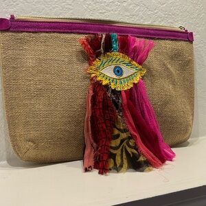 A very stylish jute. Clutch medium size with colorful ribbon